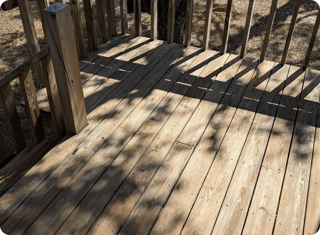 Sunlit wooden deck with railing