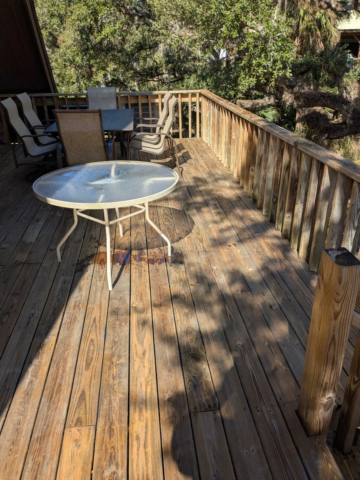 Sunlit patio with chairs and table